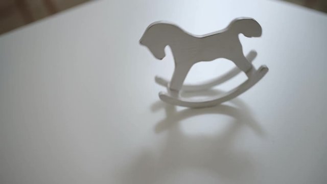 Swinging light vintage horse toy on white table