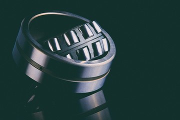 Close-up of a set of ball and roller bearings on a dark background