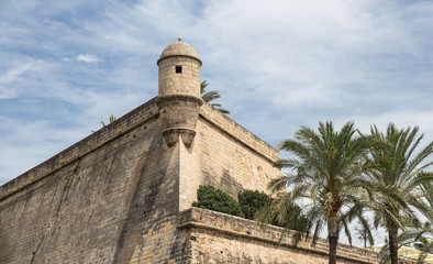 Fototapeta na wymiar View of the ancient walls of the fortress Bastió de Sant Pere & Pont de la Riera