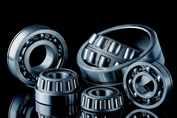 Close-up of a set of ball and roller bearings on a dark background
