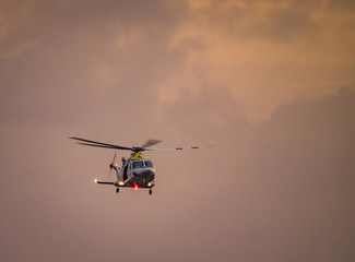 Fototapeta na wymiar Helicopter in the sunset over the Caribbean island of Curacao