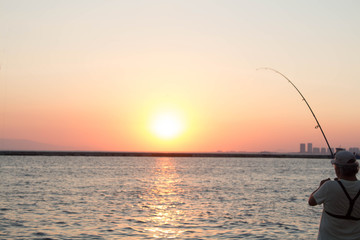 fisherman catching sun