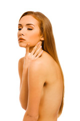 Obraz premium Sexy nude woman covering breast and touching her face with pleasure. Body care.