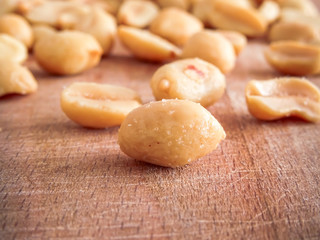 peanut on the wooden and blurry background salty close up