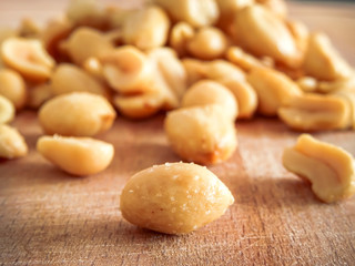 peanut on the wooden and blurry background salty close up