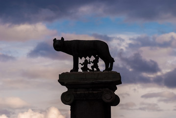 Legendary Capitoline Wolf with royal twins at the top of Capitol Hill in Rome, against beautiful clouds