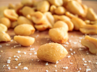 peanut on the wooden and blurry background salty close up