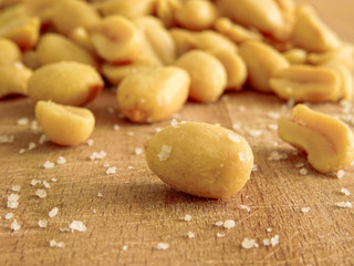 peanut on the wooden and blurry background salty close up