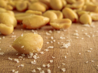 peanut on the wooden and blurry background salty close up