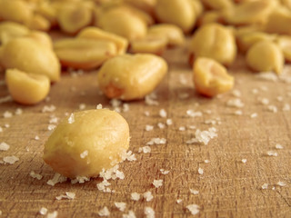 peanut on the wooden and blurry background salty close up
