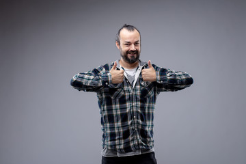 Happy gleeful man giving a double thumbs up