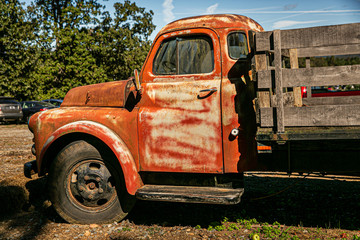 Vintage old rusted pickup truck with wooden back for farming and hauling crops - obrazy, fototapety, plakaty