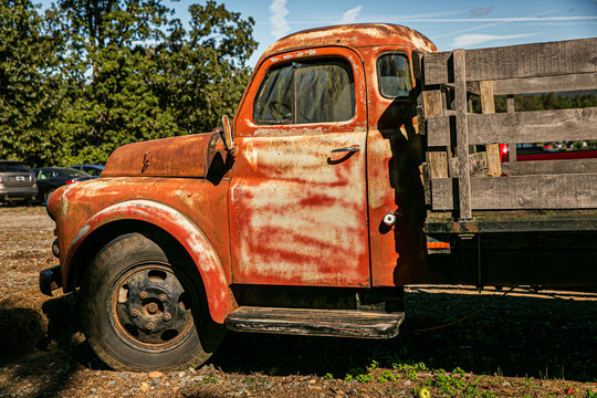 Vintage old rusted pickup truck with wooden back for farming and hauling crops