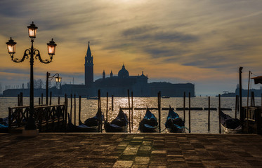 View of winter sunset sky with mist over Saint George Island in Venice Lagoon from city waterfront