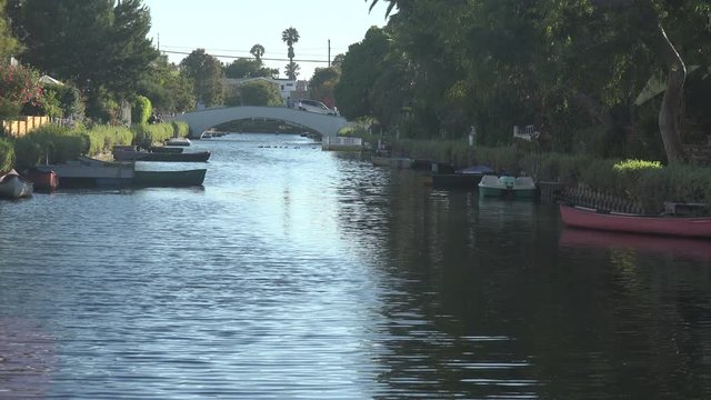 A car crosses a quaint bridge at the beautiful Venice Canals in Southern California
