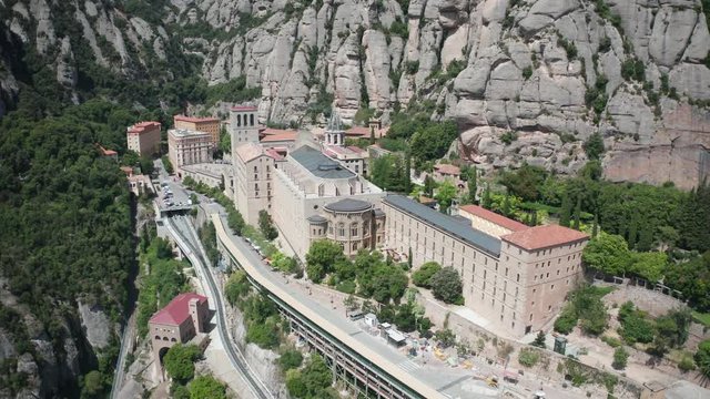 Drone view of saw mountain Montserrat with Santa Maria de Montserrat monastery. Site of Benedictine abbey located on mountain in Barcelona, Catalonia, Spain