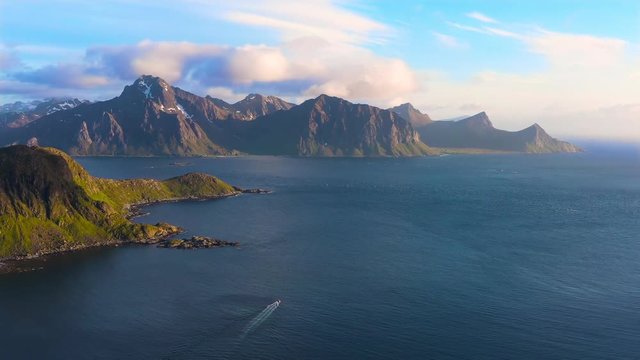 aerial view. flight over the sea,view on the Flakstadoya from Haukland beach and Mannen peak. Camera move left to right .Lofoten Islands,Norway