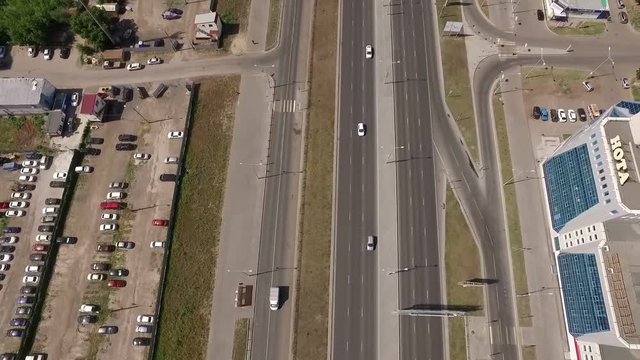top moving view from drone of modern new road with roundabout in big city in summer day