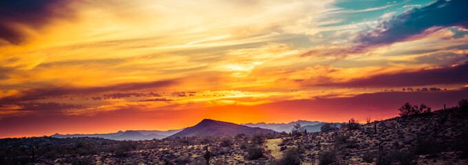 A sunset over the Sonoran Desert of Arizona with high altitude clouds panorama.