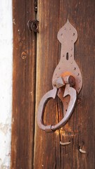 old rusty handle of wooden door of monastery