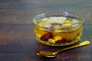 Coconut jelly in sweet longan syrup mixed with red beans, pineapples and ginkgo. Thai desserts. Selective focus, space for texts.