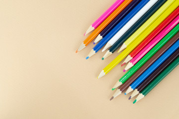 Lots of colorful pencils on a nice beige background