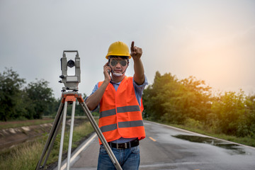 Young man engineer is using Surveyor equipment tacheometer or theodolite worker on the road.