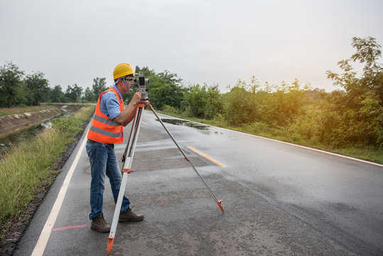 Young man engineer is using Surveyor equipment tacheometer or theodolite worker on the road.