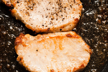 Cooking two steaks close-up. Sliced meat fillet