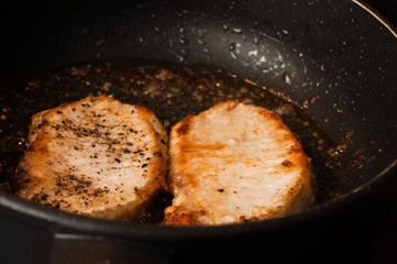 Cooking two steaks close-up. Sliced meat fillet