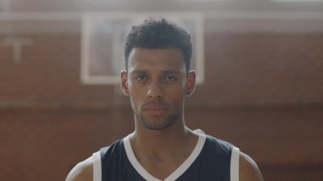 CU Portrait of young confident African American black college basketball player pointing a ball into camera. Shot on ARRI Alexa Mini, 4K RAW graded footage
