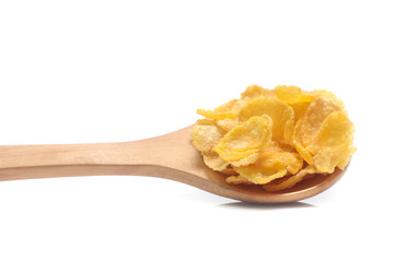 Cornflakes on spoon wood isolated on white background