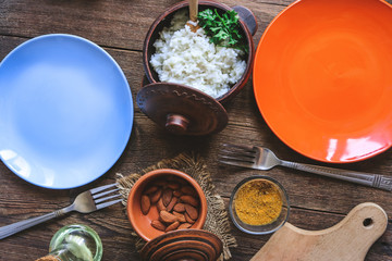Multi-colored plates on the kitchen table.