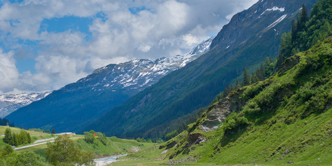 valley and river between high snowy mountains, panoramic shot