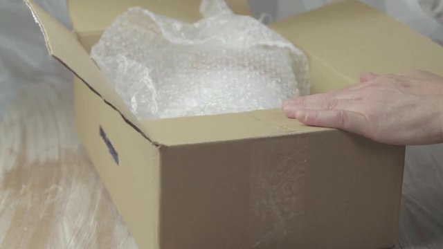 Packing a box with bubble wrap