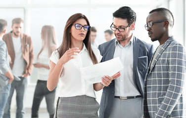 group of business people discussing a business document