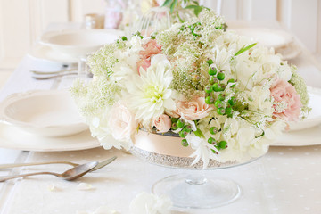 Floral decorations on summer party table. Centerpiece with rose, dahlia and hortensia flowers