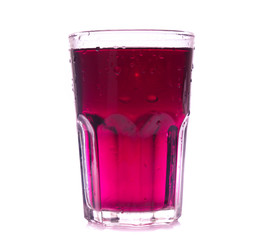 Glass of red grape juice with fruit isolated on white