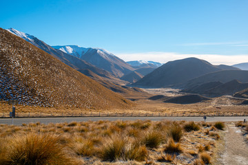 dramatic rugged barren country driving through Lindis alpine Pass in New Zealand