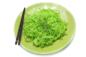 green noodles on dish isolated on white background