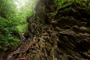 the cascade of a cold river waterfall falls on stones, cascades on a mountain river. The concept of active holidays, holidays