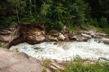 Landscape, mountain stream, cascades on a mountain river. The concept of active holidays, holidays