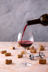 Red wine is poured into a glass. The concept of winemaking. Place under your text.