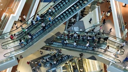 Time lapse of crowd of people in shopping mall. Escalators in modern shopping mall. - Powered by Adobe