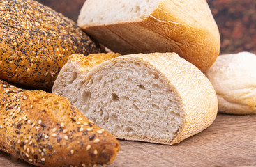 Loaf of baguette and multigrain bread close up