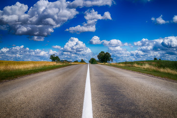 Low angle view of a tarred road receding