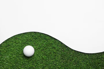 Gordijnen Golf ball and white paper on green artificial grass, top view with space for text © New Africa