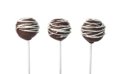 Tasty cake pops decorated with chocolate isolated on white