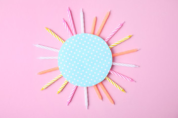 Obraz premium Colorful birthday candles and card on pink background, top view with space for text
