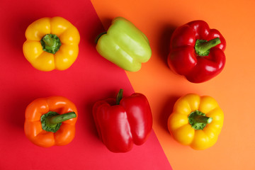 Flat lay composition with ripe bell peppers on color background